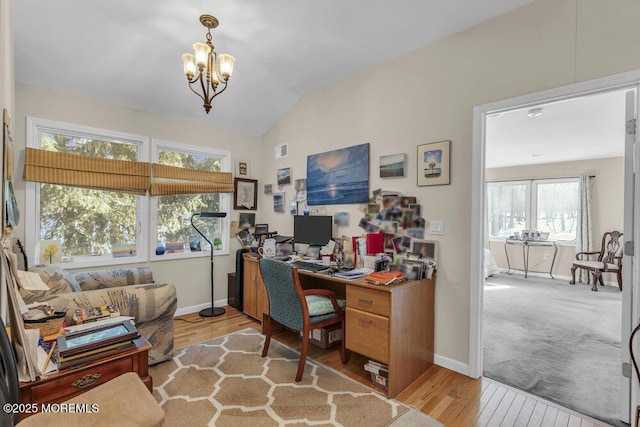 office featuring a notable chandelier, lofted ceiling, and light wood-type flooring