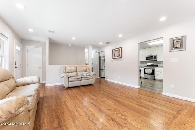 living room with light hardwood / wood-style flooring