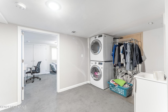 laundry area with stacked washer / dryer