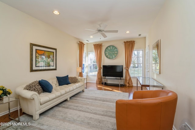 living room with ceiling fan and hardwood / wood-style flooring