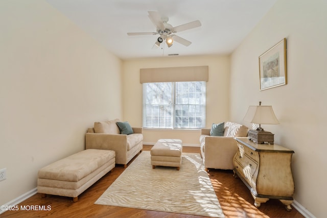 sitting room featuring ceiling fan and hardwood / wood-style floors