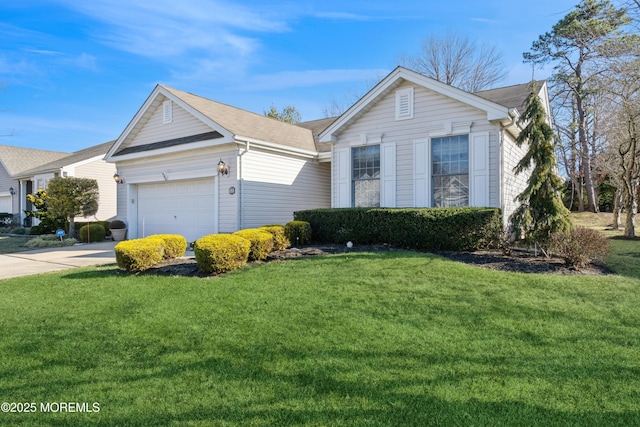 view of front of property with a garage and a front lawn