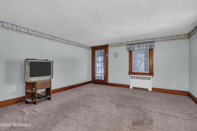 unfurnished living room with a textured ceiling, carpet flooring, and radiator heating unit