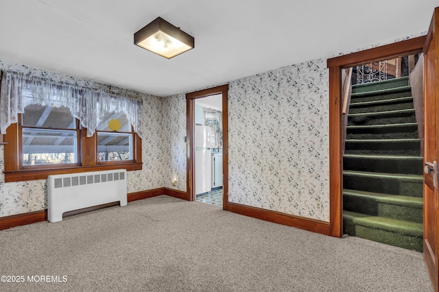 spare room with carpet floors and radiator heating unit