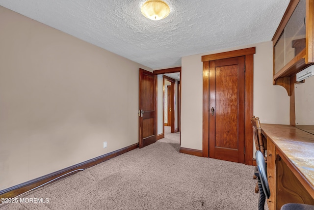 unfurnished bedroom with light colored carpet and a textured ceiling