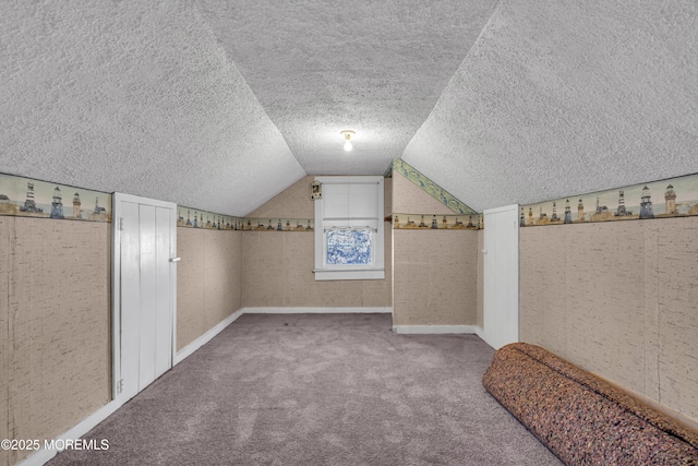 bonus room with vaulted ceiling and carpet floors