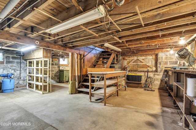 basement featuring washer / dryer and a workshop area