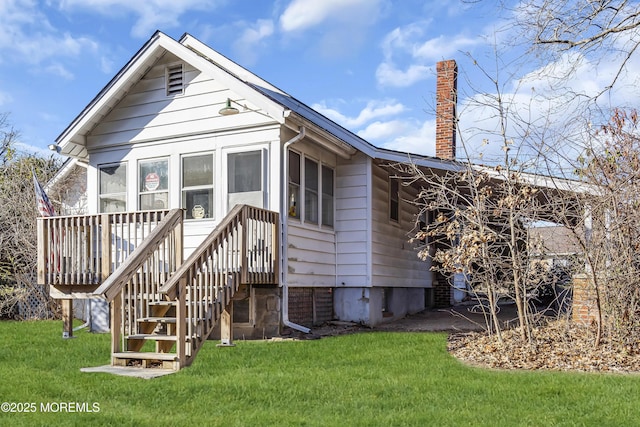 rear view of property with a yard