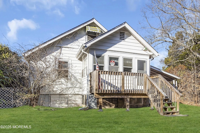 back of house with a deck and a yard