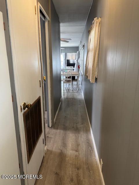 hallway with dark hardwood / wood-style flooring