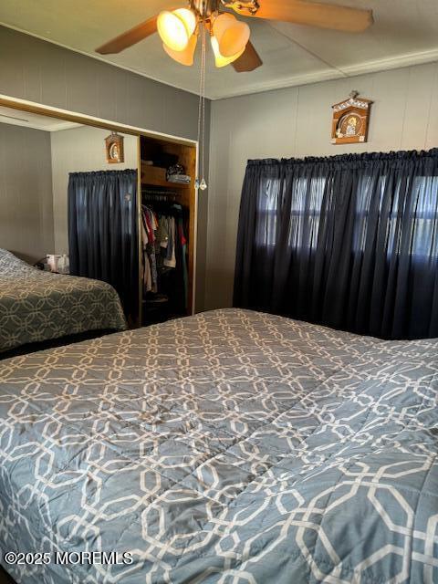 bedroom with ceiling fan and a closet