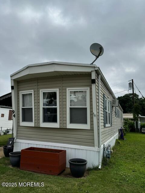 view of side of home with a lawn