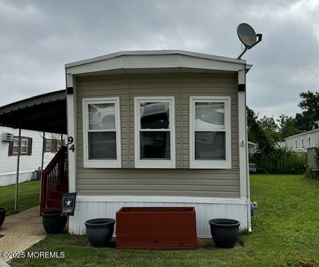 view of side of home featuring a lawn