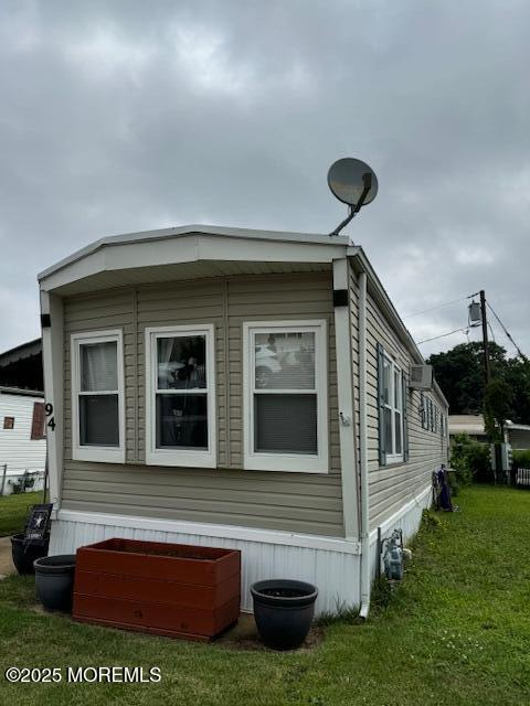 view of property exterior with a yard