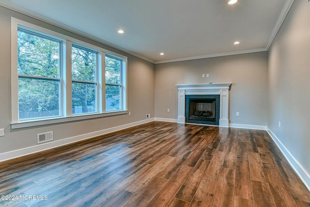 unfurnished living room with dark hardwood / wood-style floors and crown molding