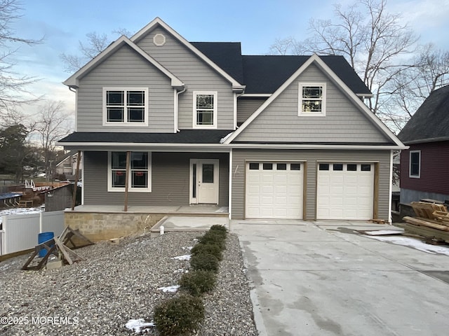 view of front facade featuring covered porch and a garage