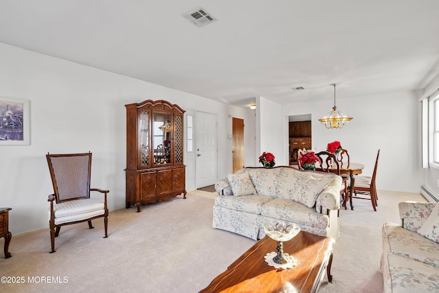 carpeted living room featuring a baseboard radiator and an inviting chandelier