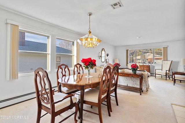 carpeted dining space with a baseboard heating unit and a notable chandelier