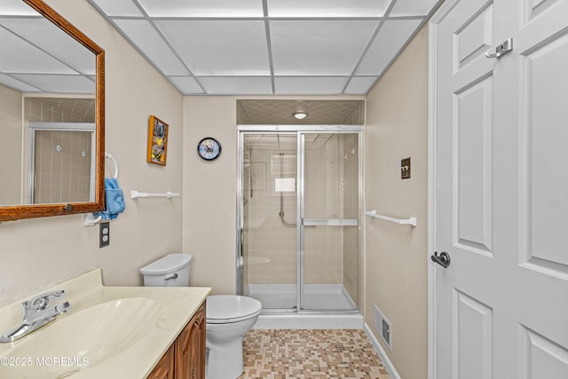 bathroom featuring a paneled ceiling, toilet, walk in shower, and vanity