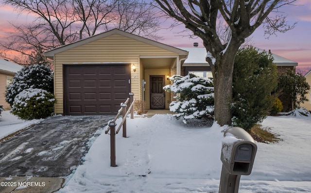 ranch-style home featuring a garage