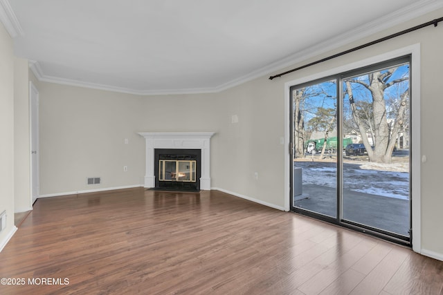 unfurnished living room with wood-type flooring and crown molding