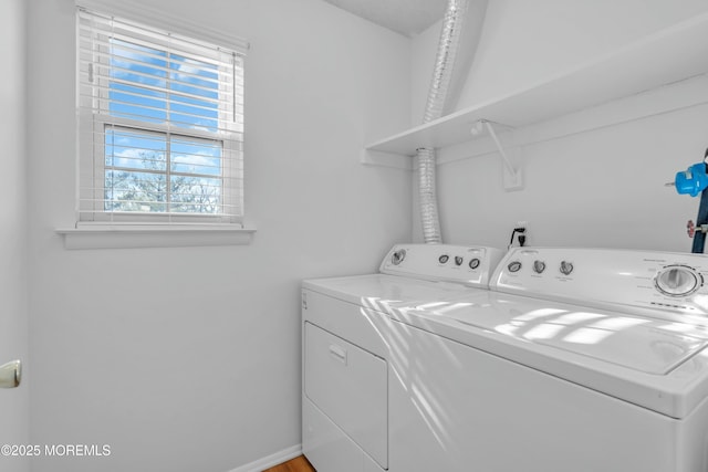 clothes washing area featuring independent washer and dryer and a healthy amount of sunlight