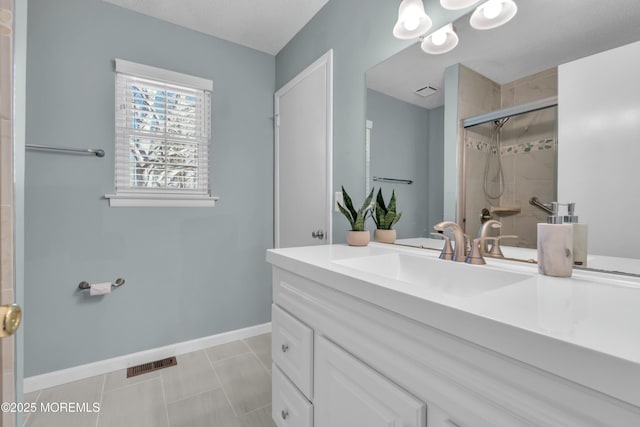 bathroom with vanity, tile patterned floors, and a shower with shower door