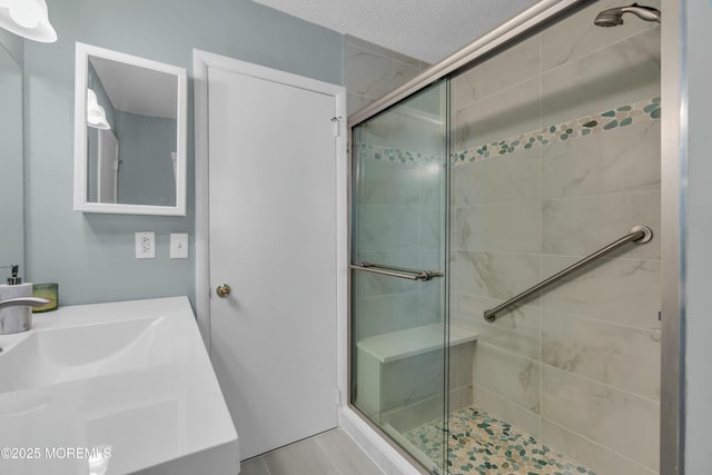 bathroom featuring sink and a shower with door