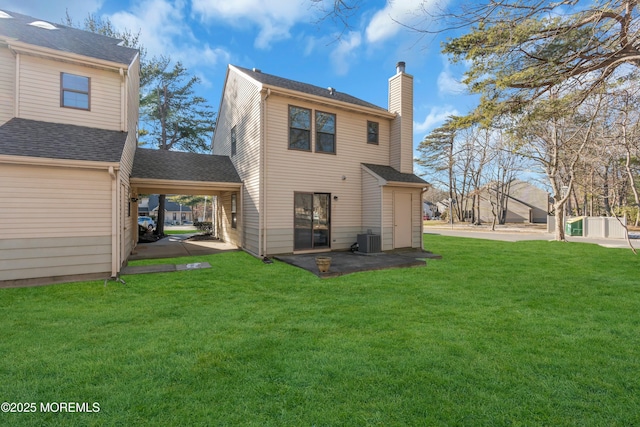 back of property with a yard, central AC unit, and a patio