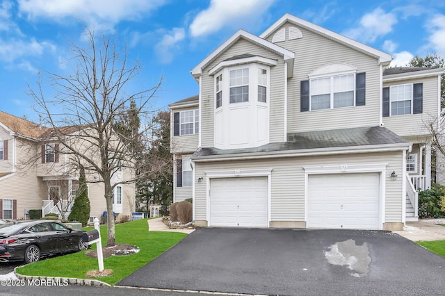 view of front of house with a front lawn and a garage