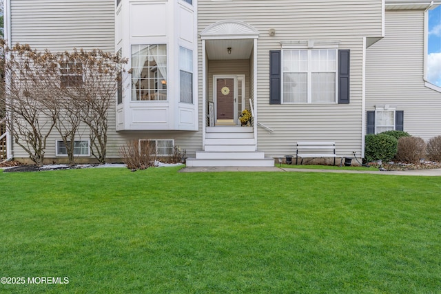 entrance to property with a lawn