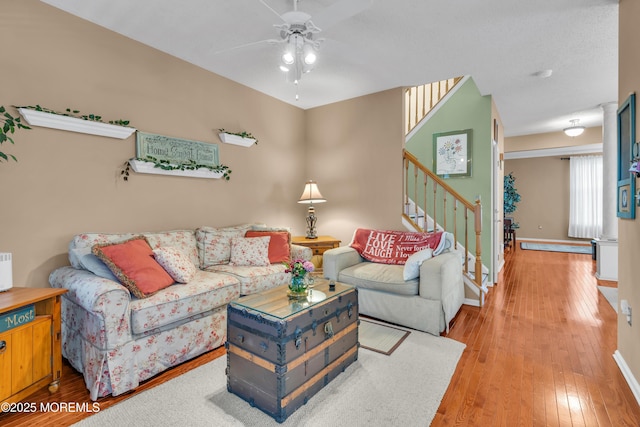 living room with ceiling fan and hardwood / wood-style floors