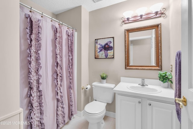 bathroom featuring toilet, tile patterned floors, a textured ceiling, a shower with curtain, and vanity