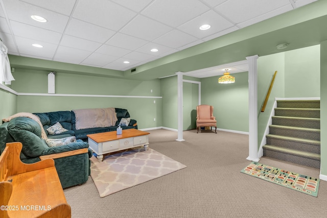 carpeted living room with a drop ceiling