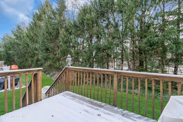 wooden terrace featuring a lawn