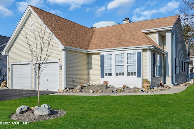 view of front of house featuring a garage and a front lawn