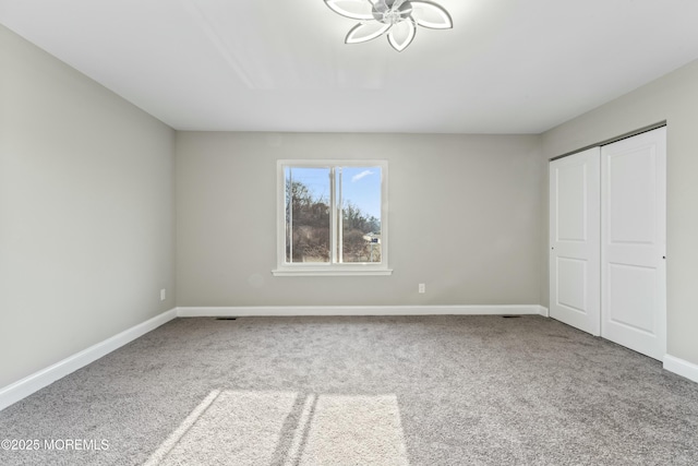 unfurnished bedroom featuring a closet and carpet flooring