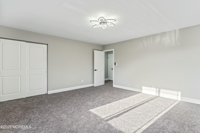 unfurnished bedroom with a closet and carpet flooring