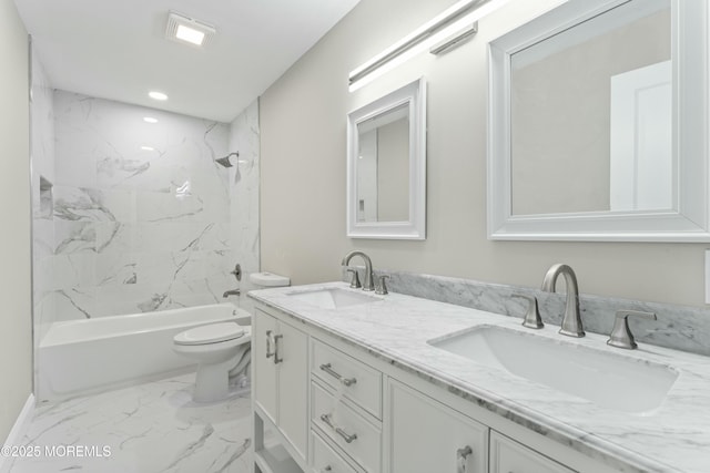 full bathroom with toilet, tiled shower / bath, and vanity