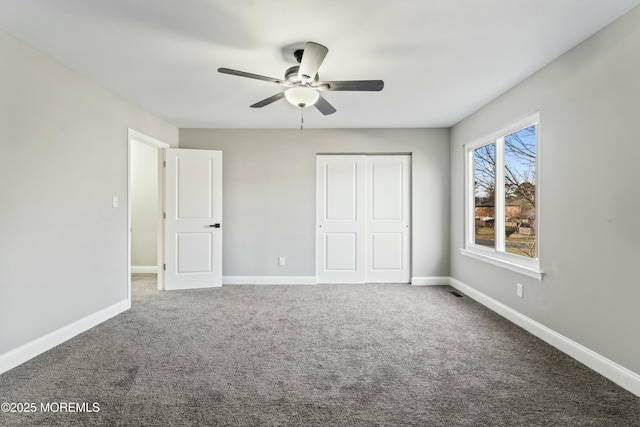 unfurnished bedroom featuring ceiling fan, carpet flooring, and a closet