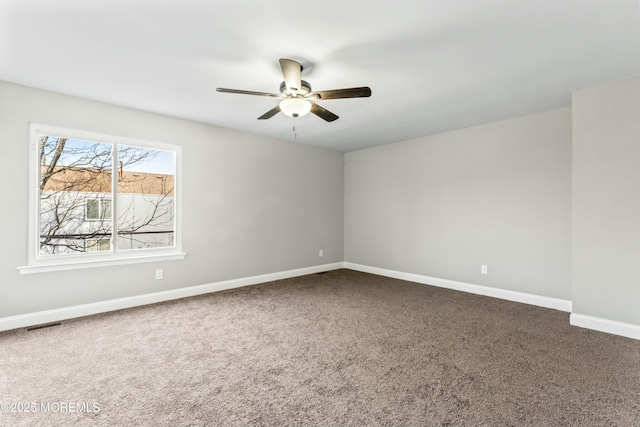 unfurnished room featuring ceiling fan and carpet