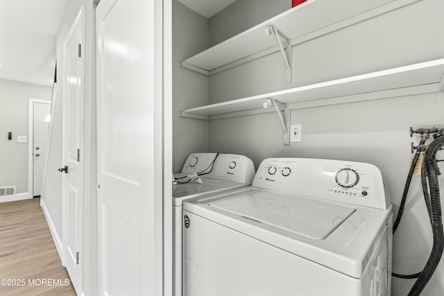 laundry room with light hardwood / wood-style flooring