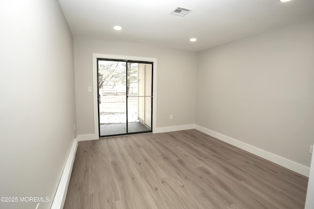 spare room with light hardwood / wood-style flooring