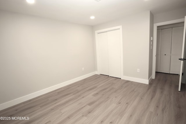 unfurnished bedroom featuring a closet and light hardwood / wood-style flooring