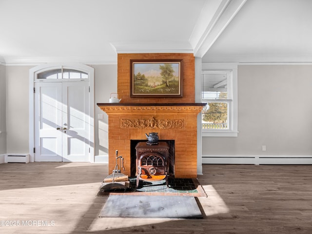 interior details with ornamental molding, a wood stove, and a baseboard heating unit