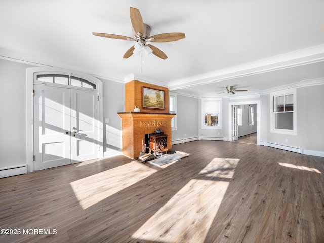 unfurnished living room with baseboard heating, beamed ceiling, ornamental molding, dark wood-type flooring, and a wood stove