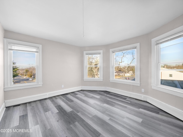 unfurnished room with hardwood / wood-style flooring