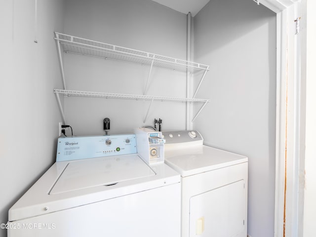 clothes washing area with washer and clothes dryer