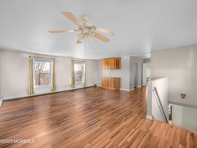 unfurnished living room with ceiling fan and light wood-type flooring