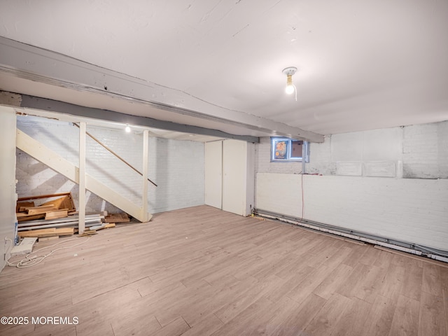 basement with light hardwood / wood-style flooring